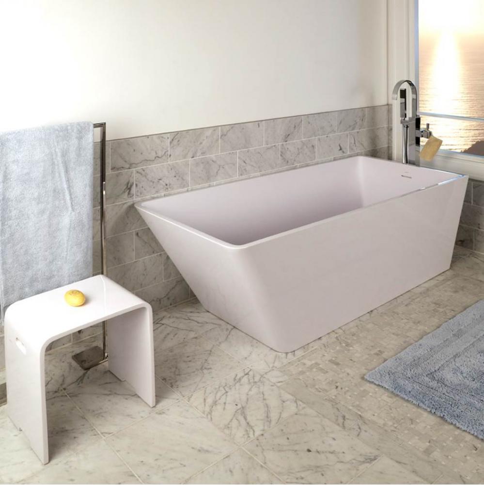 Free-standing soaking bathtub made of white solid surface with an overflow and polished chrome dra